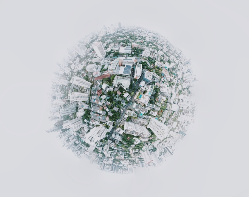 Little planet covered by a city, surrounded by mist
