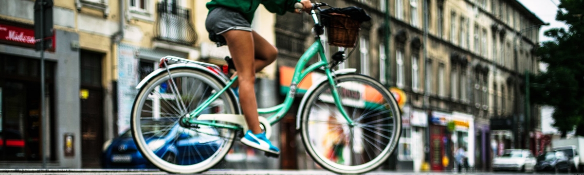Woman on a green bike.